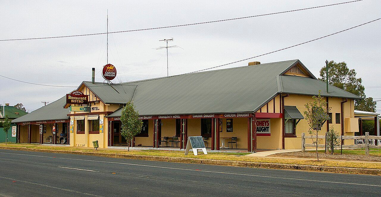 A Large Yellow Building With A Gray Roof Is Next To A Road — James Fast Freight in Uranquinty, NSW