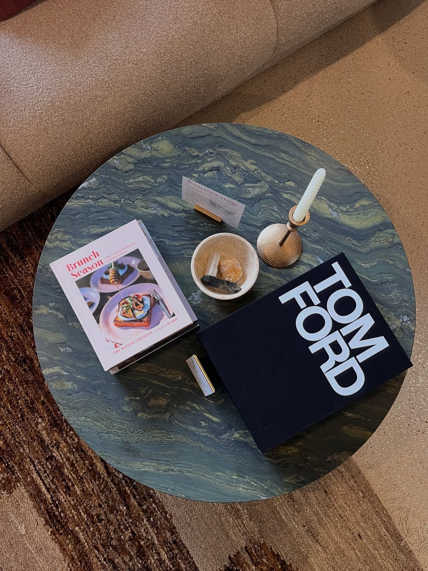Round marble table with books, candle holder, and small dish — Southeast Stone Pty Ltd In Caloundra West, QLD
