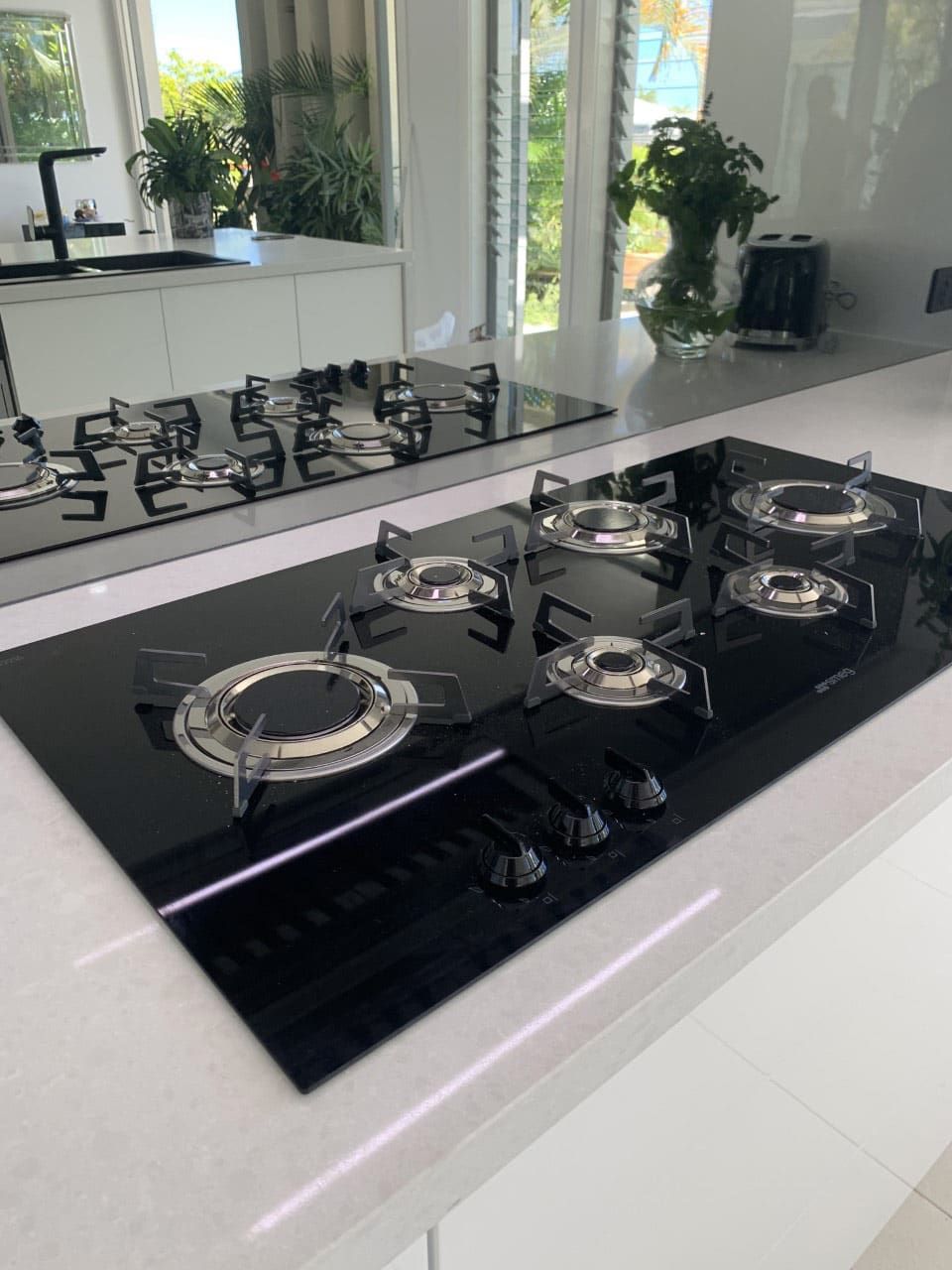 A Black Stove Top Oven Is Sitting On Top Of A Counter In A Kitchen — Southeast Stone Pty Ltd In Gympie, QLD