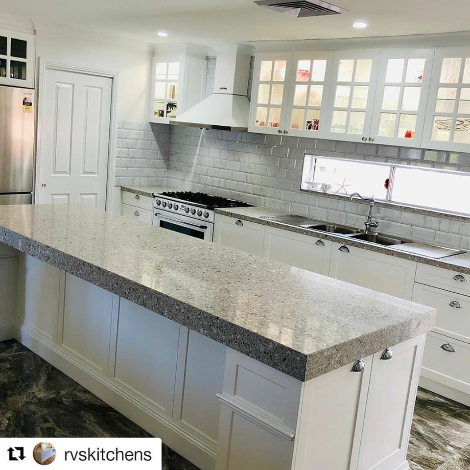 A Kitchen With White Cabinets And Granite Counter Tops — Southeast Stone Pty Ltd In Caloundra, QLD