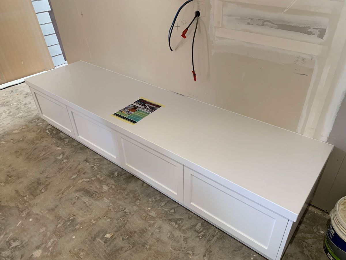 A White Bench Is Sitting On A Concrete Floor In A Room — Southeast Stone Pty Ltd In Sunshine Coast, QLD