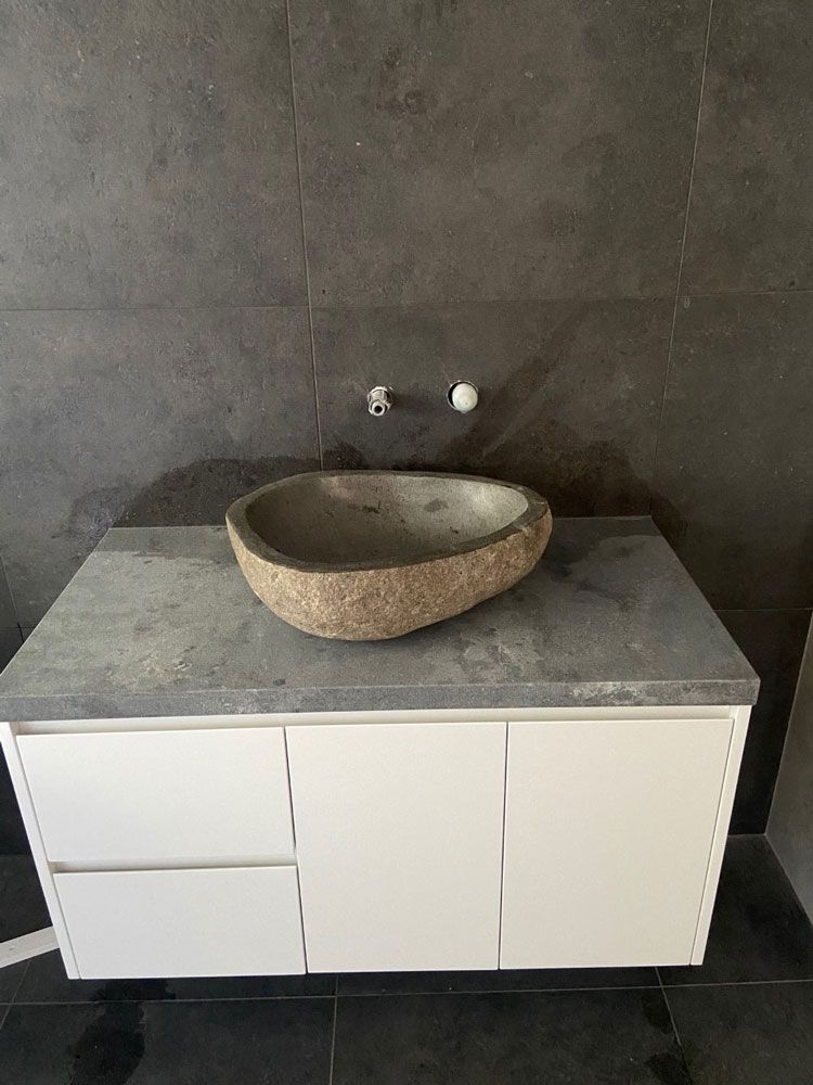 A Bathroom Vanity With A Stone Sink On Top Of It — Southeast Stone Pty Ltd In Noosa, QLD