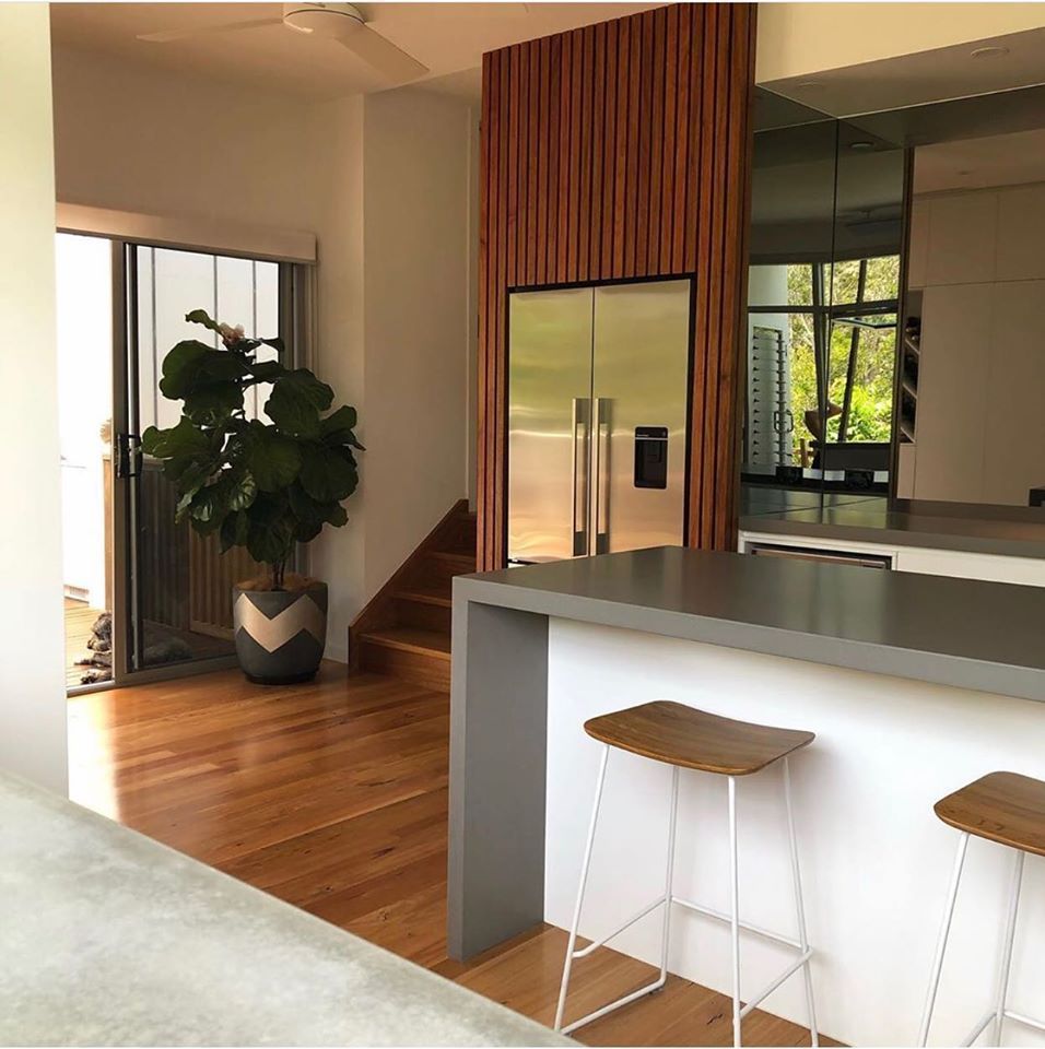 A Kitchen With A Stainless Steel Refrigerator And Stools  — Southeast Stone Pty Ltd In Gympie, QLD