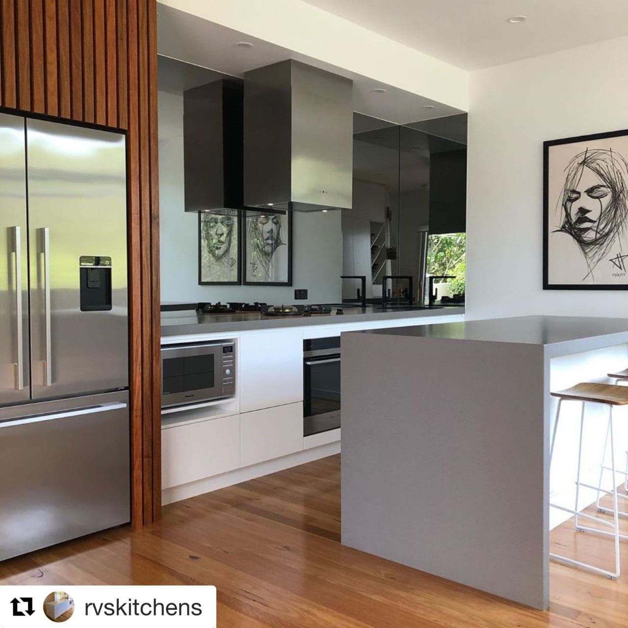 A Kitchen With Stainless Steel Appliances And A Painting On The Wall — Southeast Stone Pty Ltd In Sunshine Coast, QLD