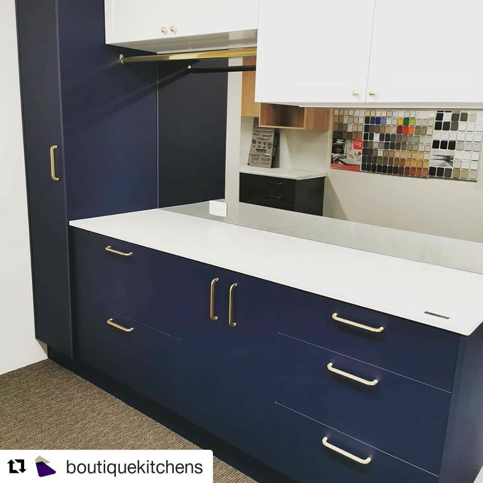 A Kitchen With Blue Cabinets And White Counter Tops — Southeast Stone Pty Ltd In Noosa, QLD