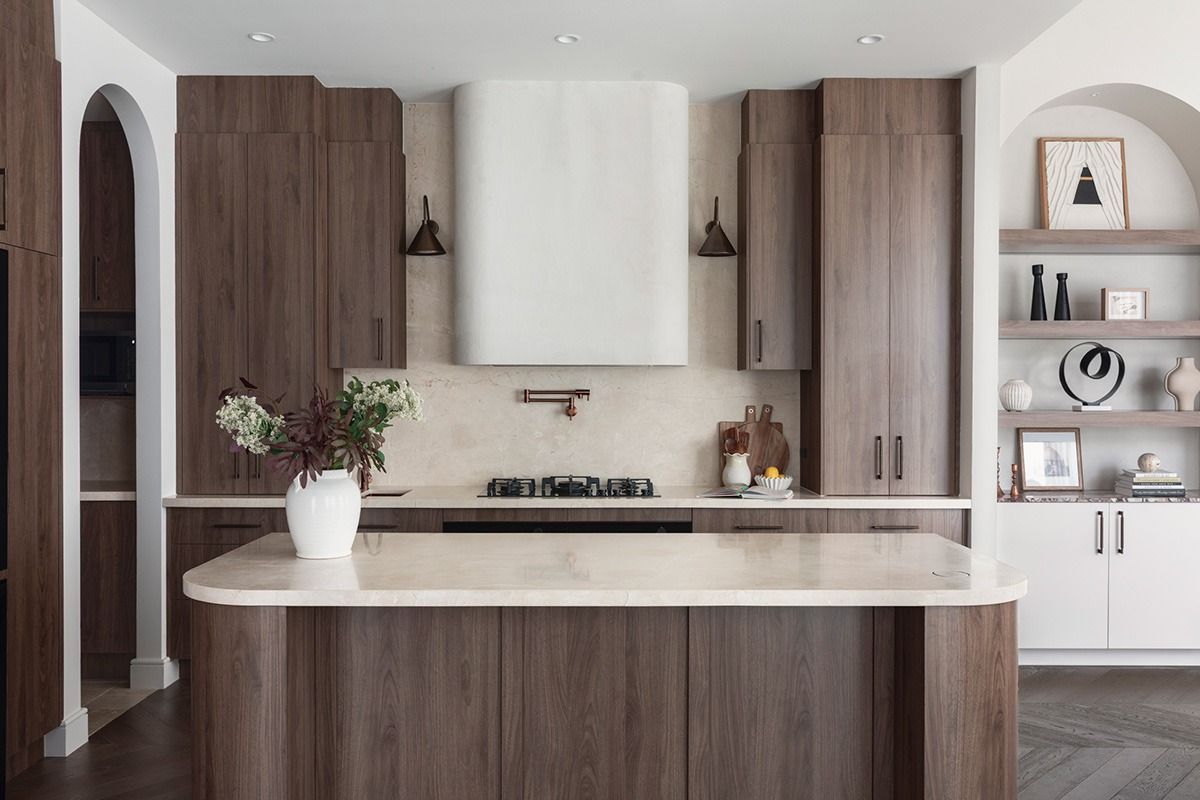 Modern kitchen with wood cabinets, white island, and open shelving in a bright, neutral interior — Southeast Stone Pty Ltd In Caloundra West, QLD