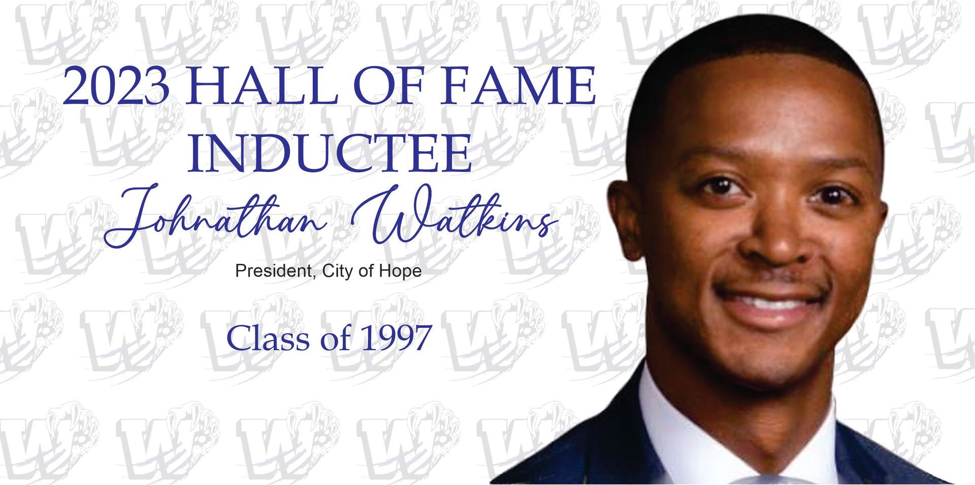 2023 Hall of Fame Inductee Jonathan Watkins. Headshot of smiling man in a suit, 