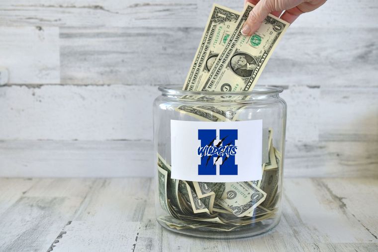 Hand placing dollar bills into a jar with a blue and white 