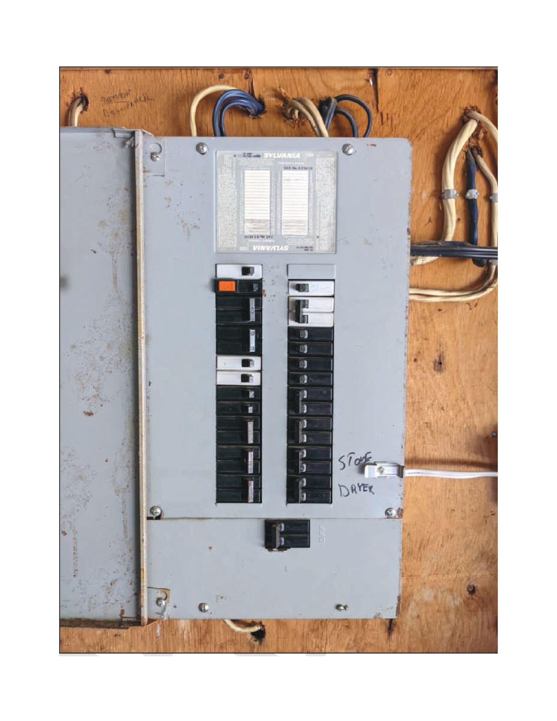 A close up of an electrical panel on a wooden wall