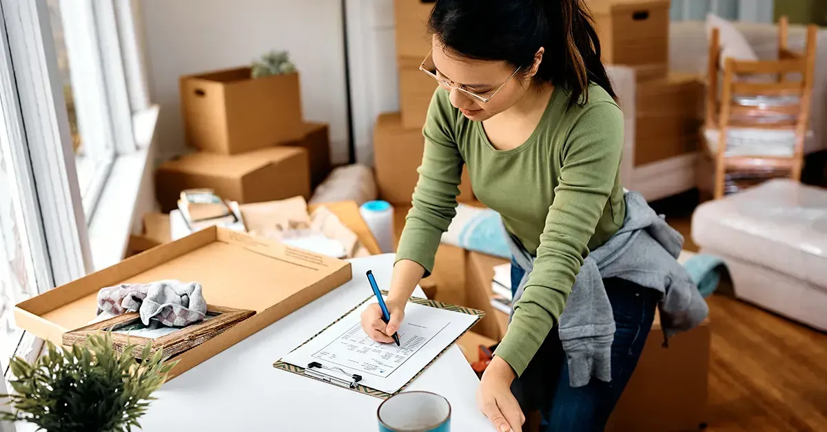 Woman making her First Apartment Checklist