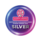 Purple circular badge reading “Tourism Awards,” “Destination Management Board Tourism Awards 2023,” and “SILVER”