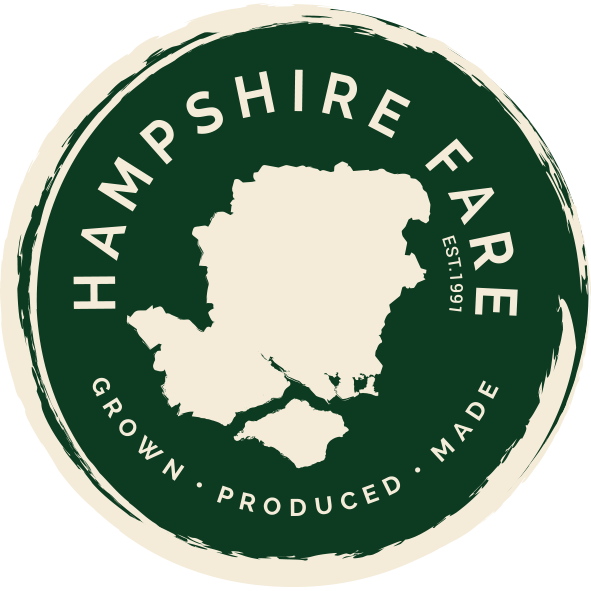 Hampshire Fare logo with white pig on dark green background and “Proud to champion local” slogan