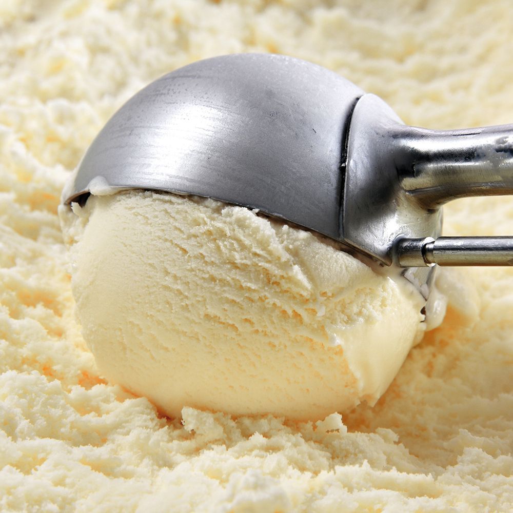 Vanilla ice cream scooped from a tub with a metal ice cream scoop