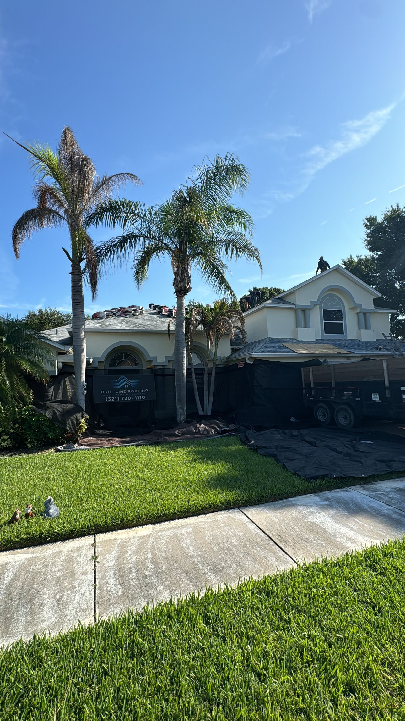 Driftline Roofing crew completing a residential roof replacement with property protection