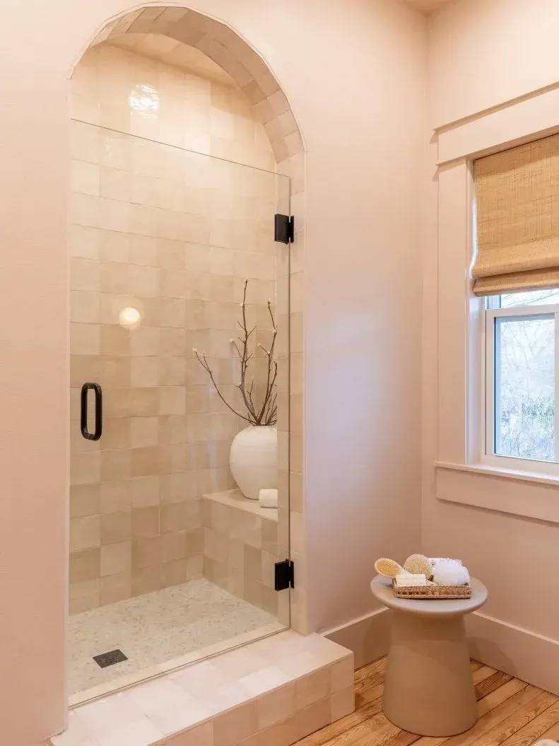 A bathroom with a walk in shower and a window. A bathroom with a walk in shower and a window.