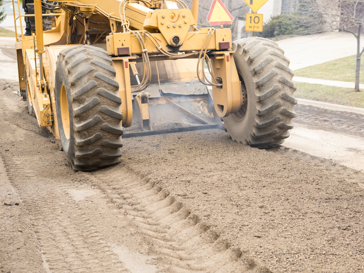 A bulldozer is working on a road with a speed limit of 10 A bulldozer is working on a road with a speed limit of 10