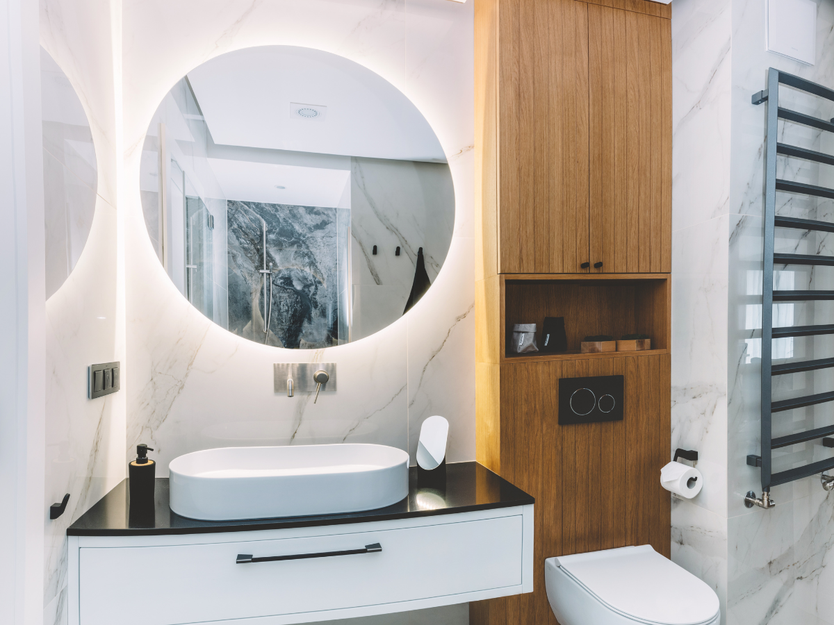 A bathroom with a sink , toilet and mirror. A bathroom with a sink , toilet and mirror.
