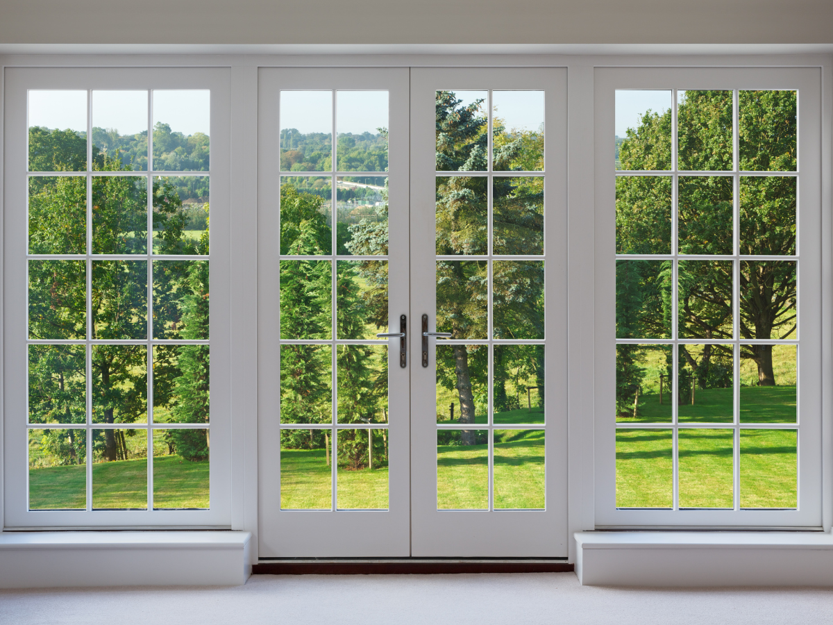 A large window with a view of a park and trees A large window with a view of a park and trees