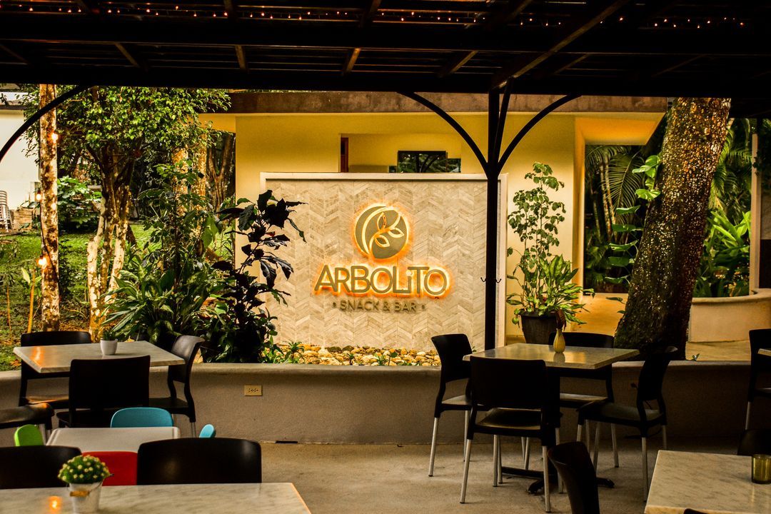 Un restaurante con mesas y sillas y un cartel que dice arpollo