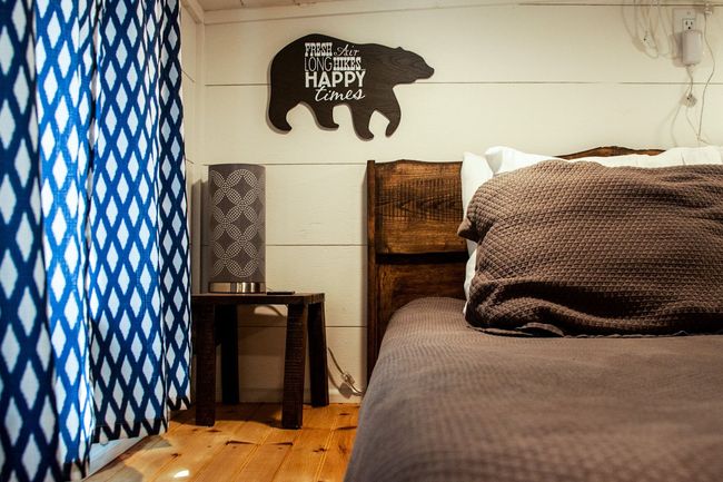 A bedroom with a bed and a sign on the wall that says 