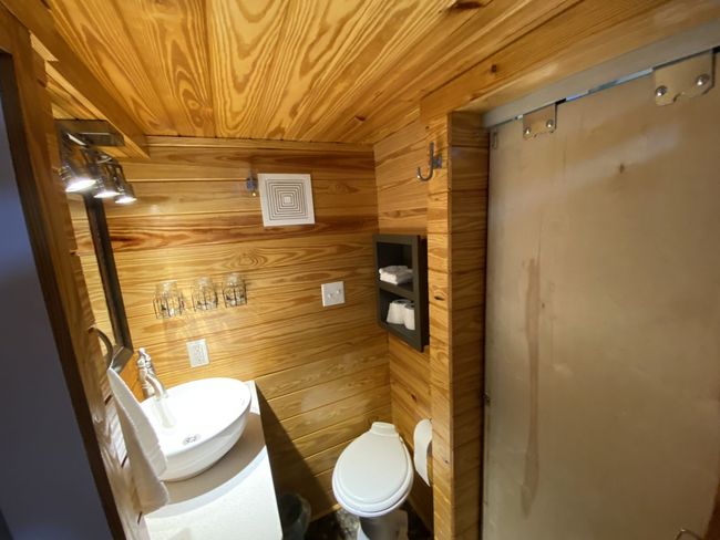 A bathroom with a toilet , sink , and shower.