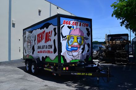 Trailer with cow-themed graphics and
