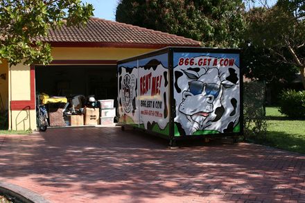 A moving container in a driveway with