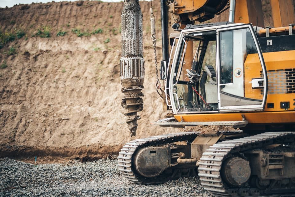 A yellow excavator is working on a construction site.