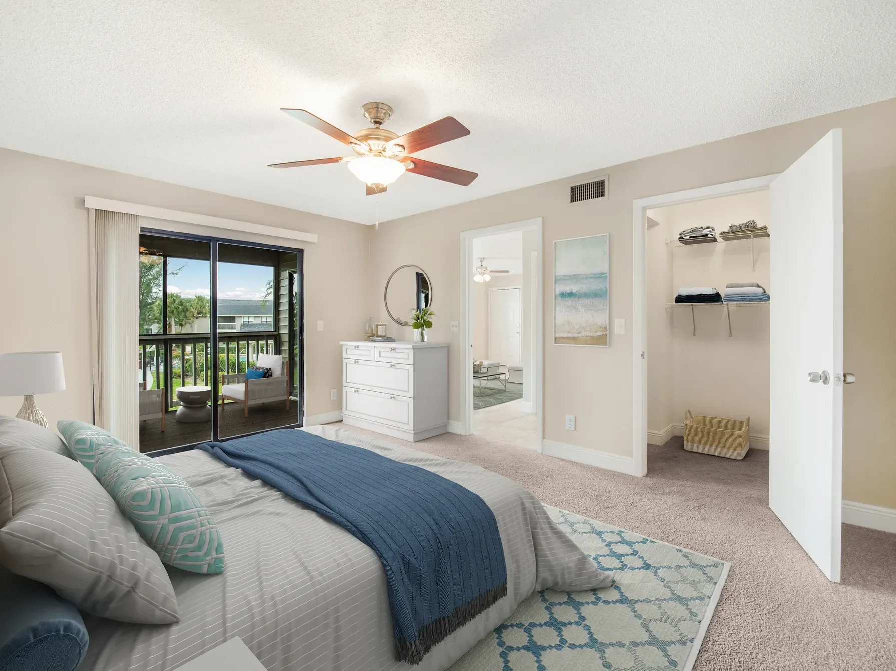 A bedroom with a large bed and a ceiling fan at Belvedere at Quail Run in Naples, FL.