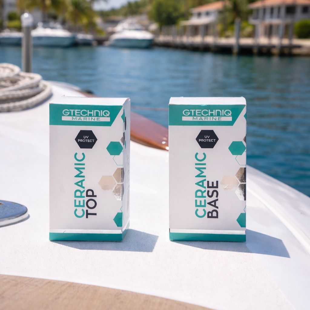 Two ceramic repair product boxes on a boat deck by the water, with yachts in the background.