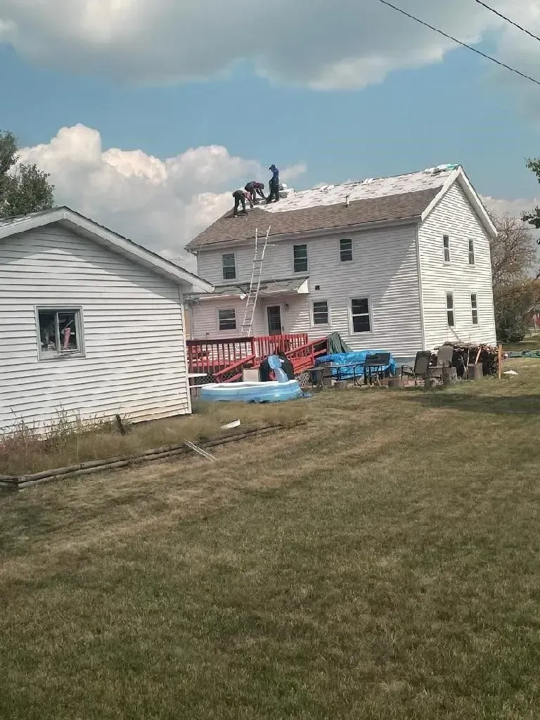 Curti Construction working on the roof of a house in La Crosse, WI