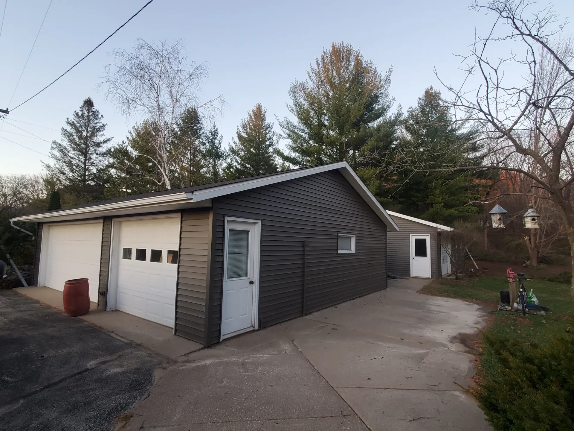 garage with new siding and roof installed by Curti Construction