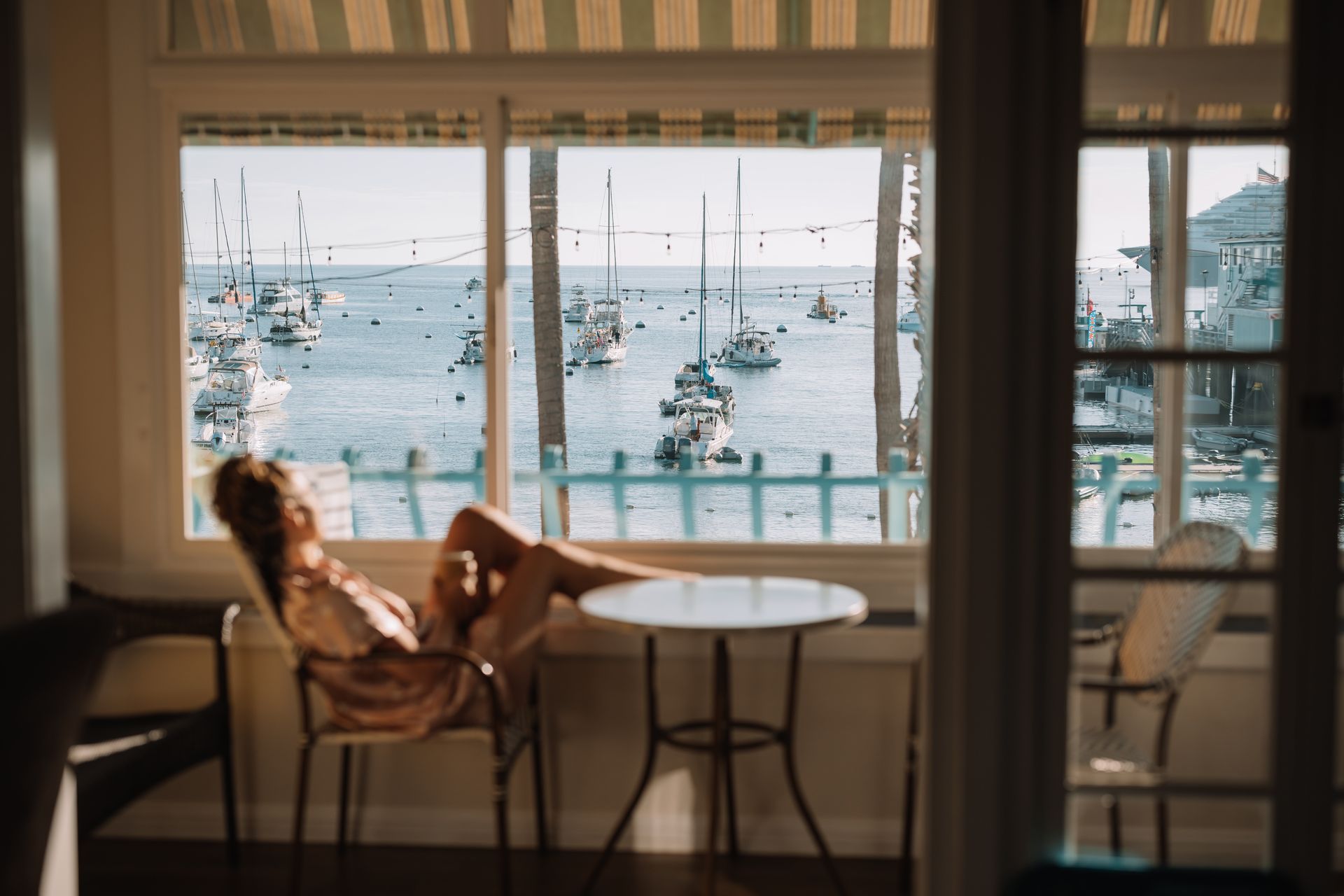 a hotel room with a queen size bed and views of the bay.