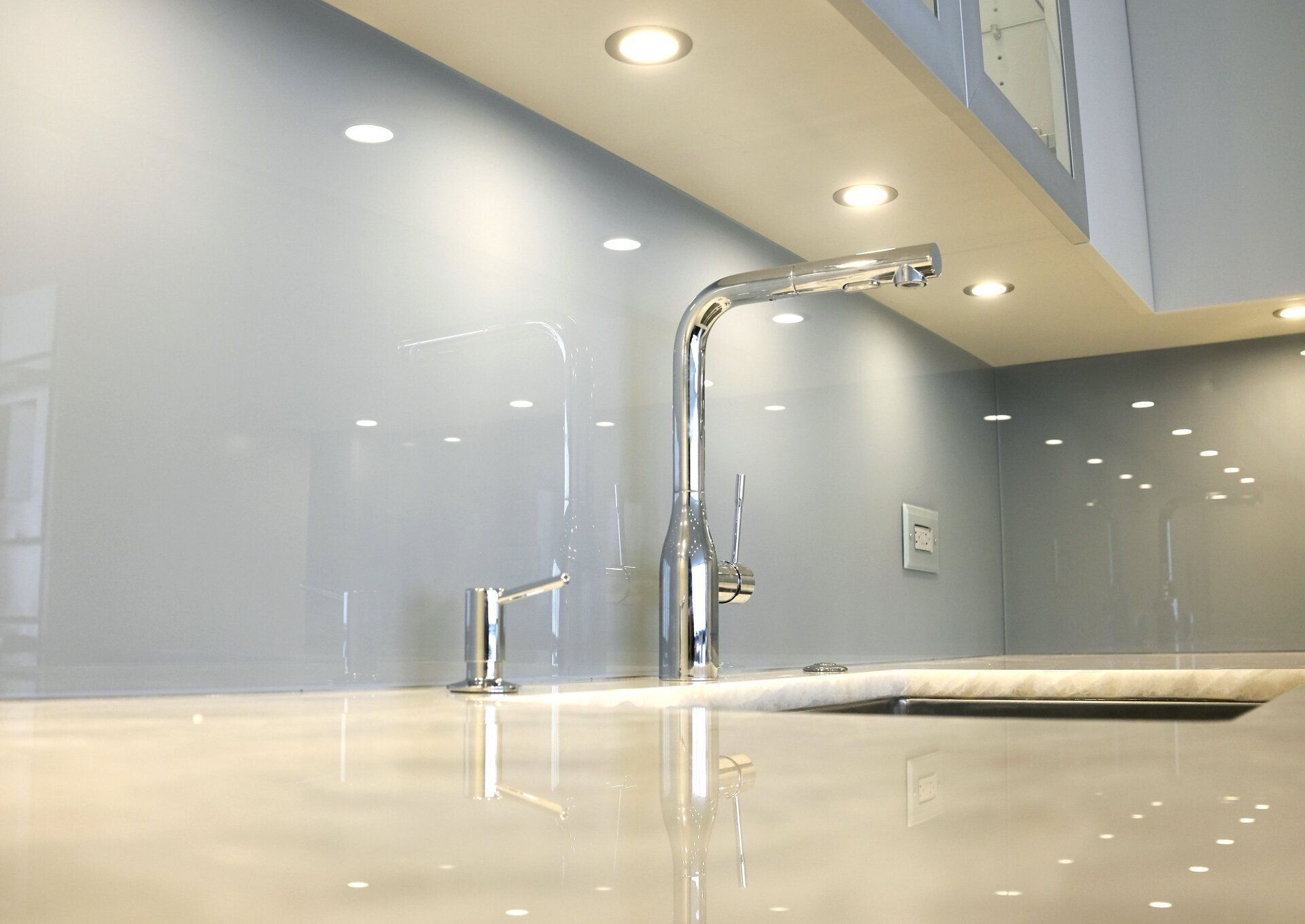 custom glass art backsplash with recessed lighting, cabinets, countertops, central texas