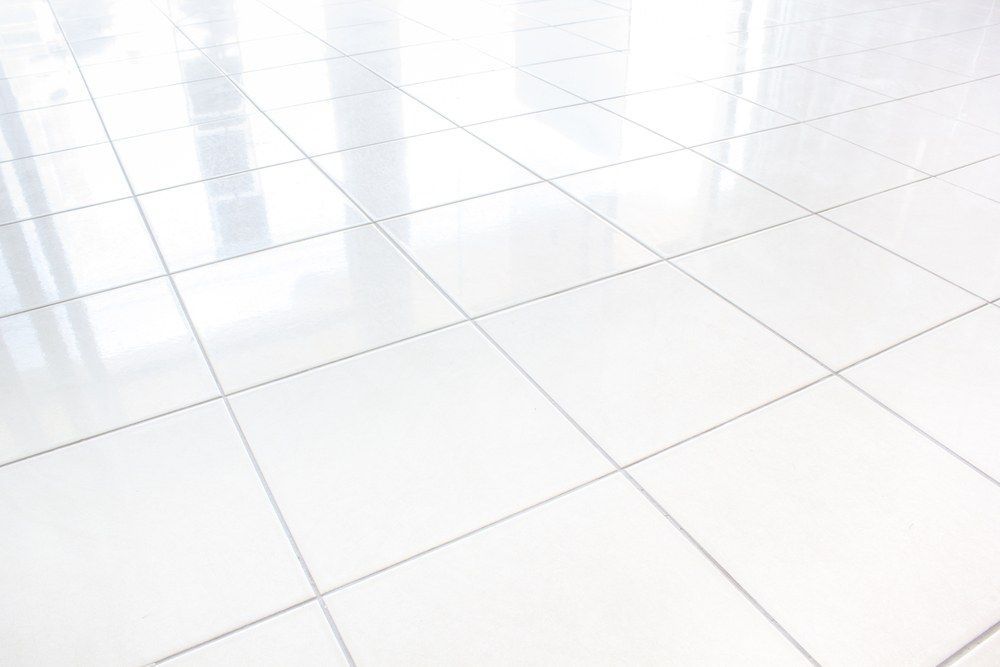 A Close up Of a White Tiled Floor in An Empty Room — Slippery Solutions In Cranbrook, QLD 