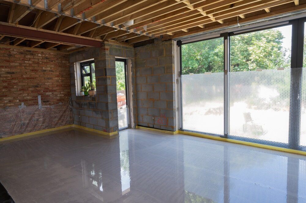 An Empty Room with A Brick Wall and A Sliding Glass Door — Slippery Solutions In Cranbrook, QLD 