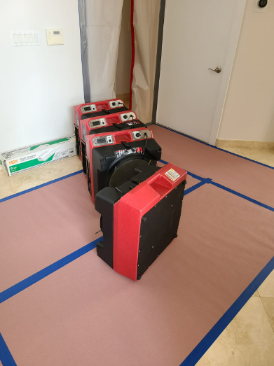 Technicians prepping fans for water damage cleanup in Fort Myers.
