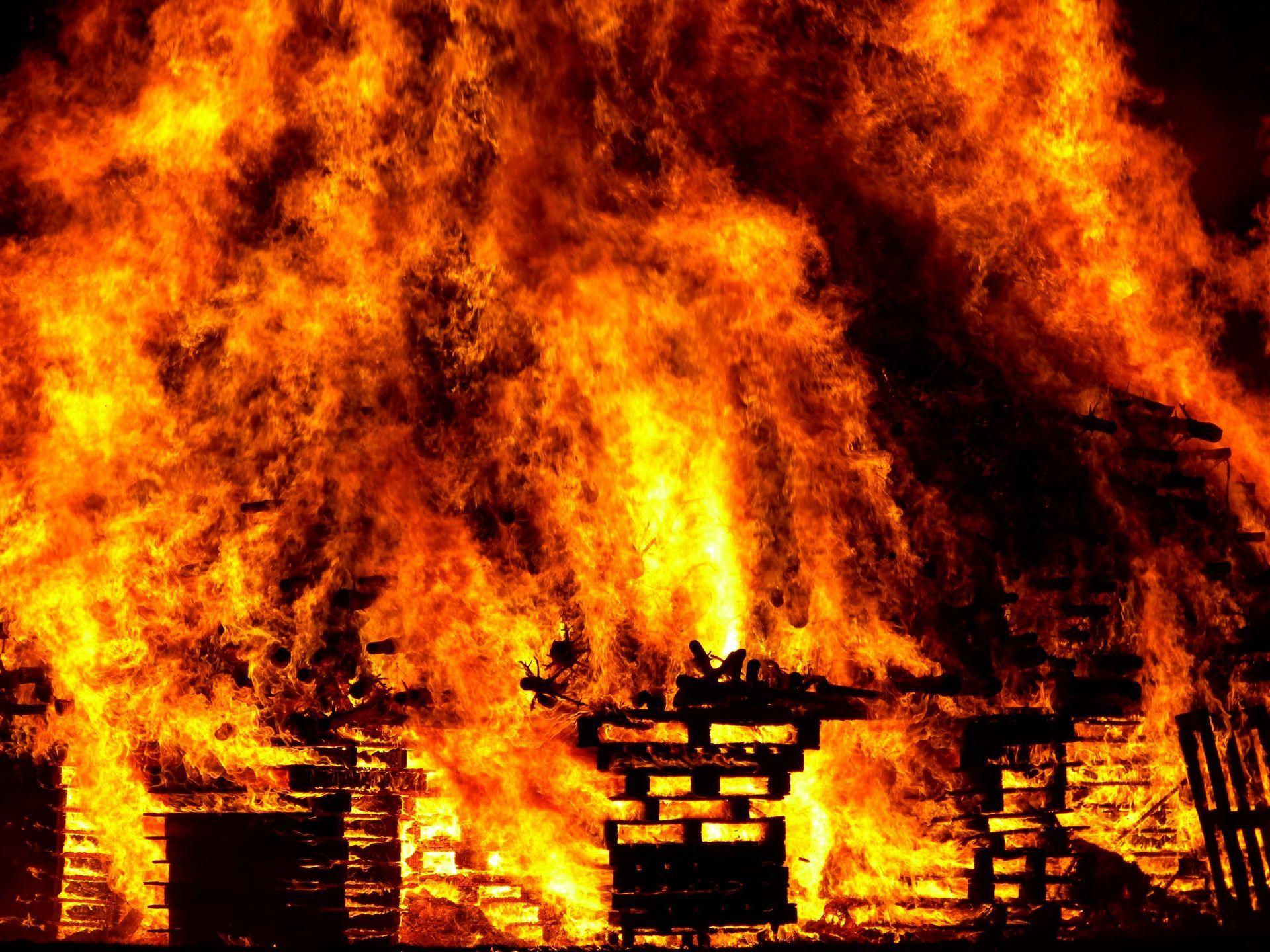 Fort Myers home engulfed in flames showing severe fire damage before restoration services
