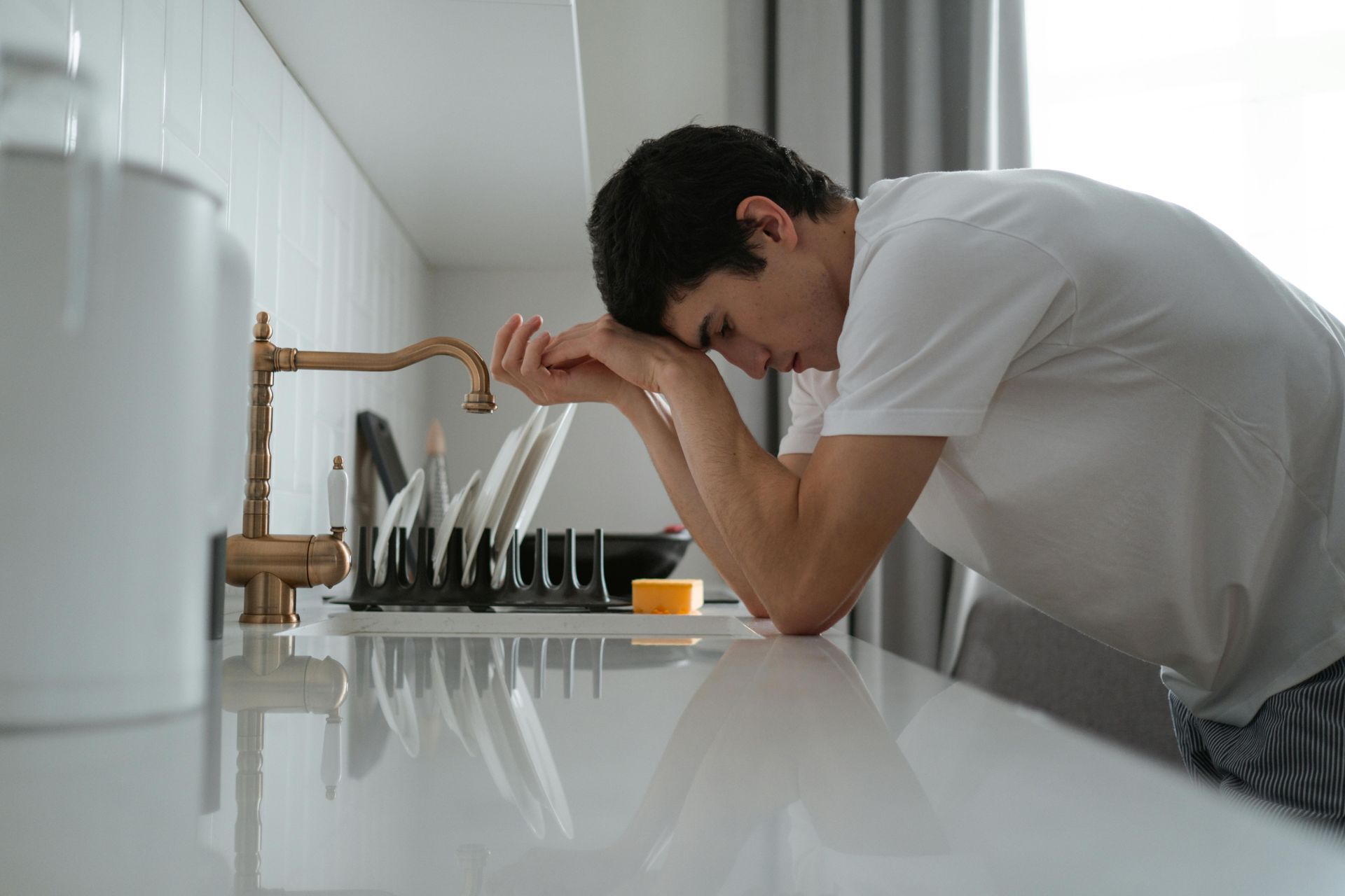 Man overwhelmed by property damage after a home disaster