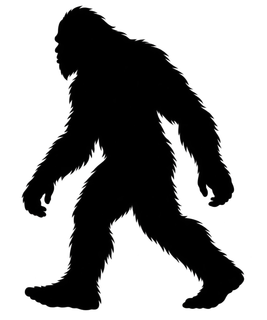 Black silhouette of a walking Bigfoot or Yeti on a white background