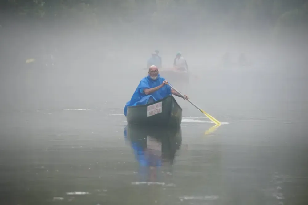 A group of people are posing after a stream clean up.