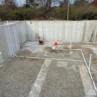 Hard plumbing for new construction is being built in a basement.