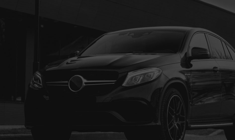 Black car parked outside of shop | Crowne Automotive