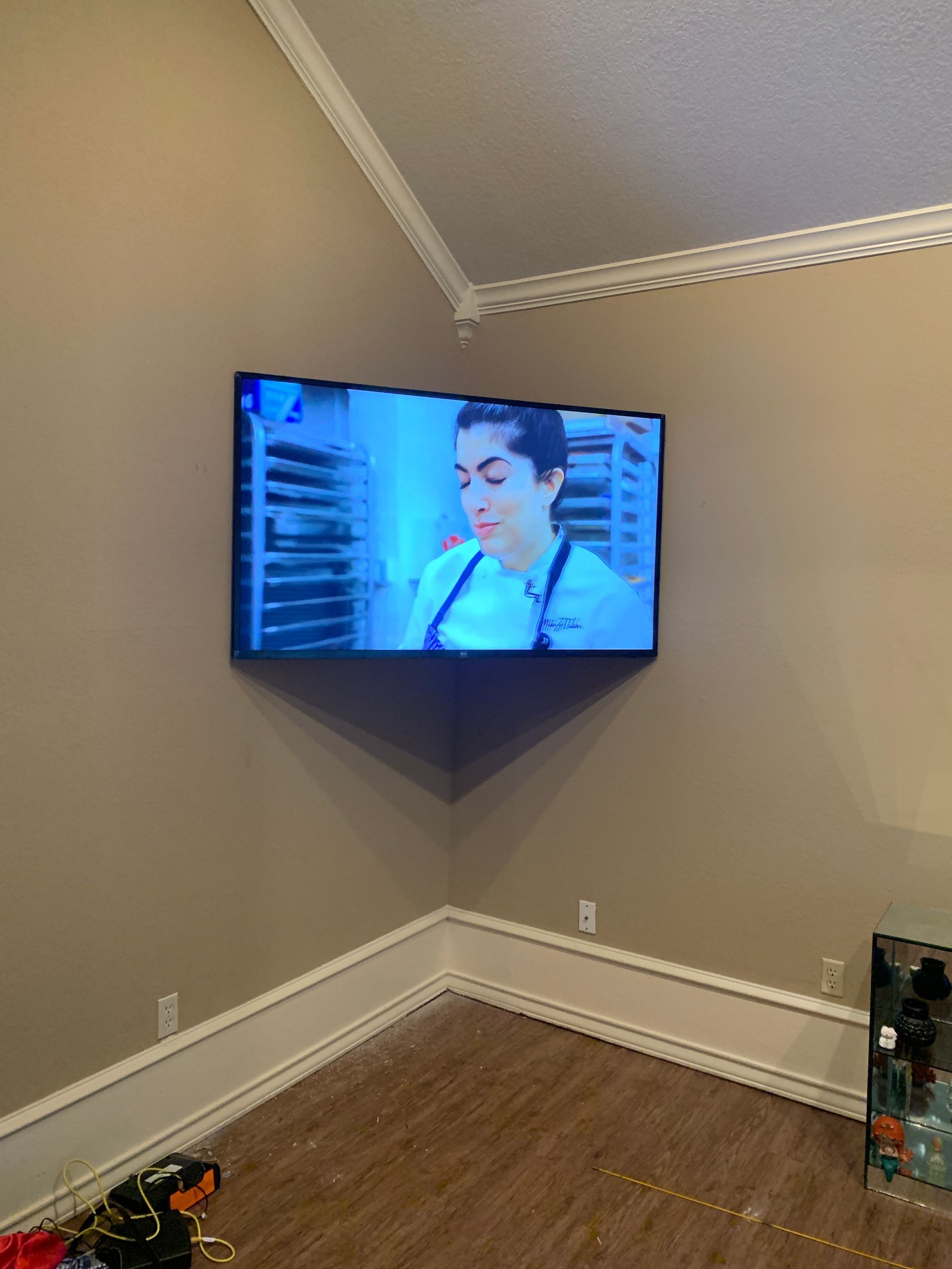 A flat screen tv is mounted on a wall in a living room.