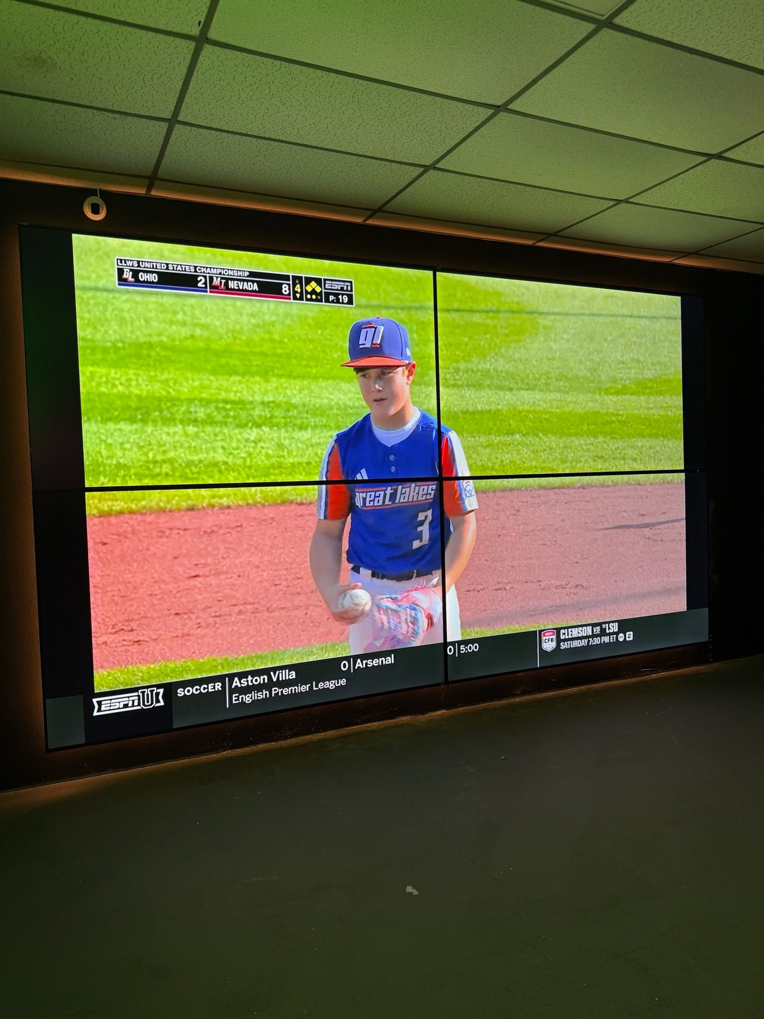 TV screen showing a baseball player in a blue uniform standing on the field