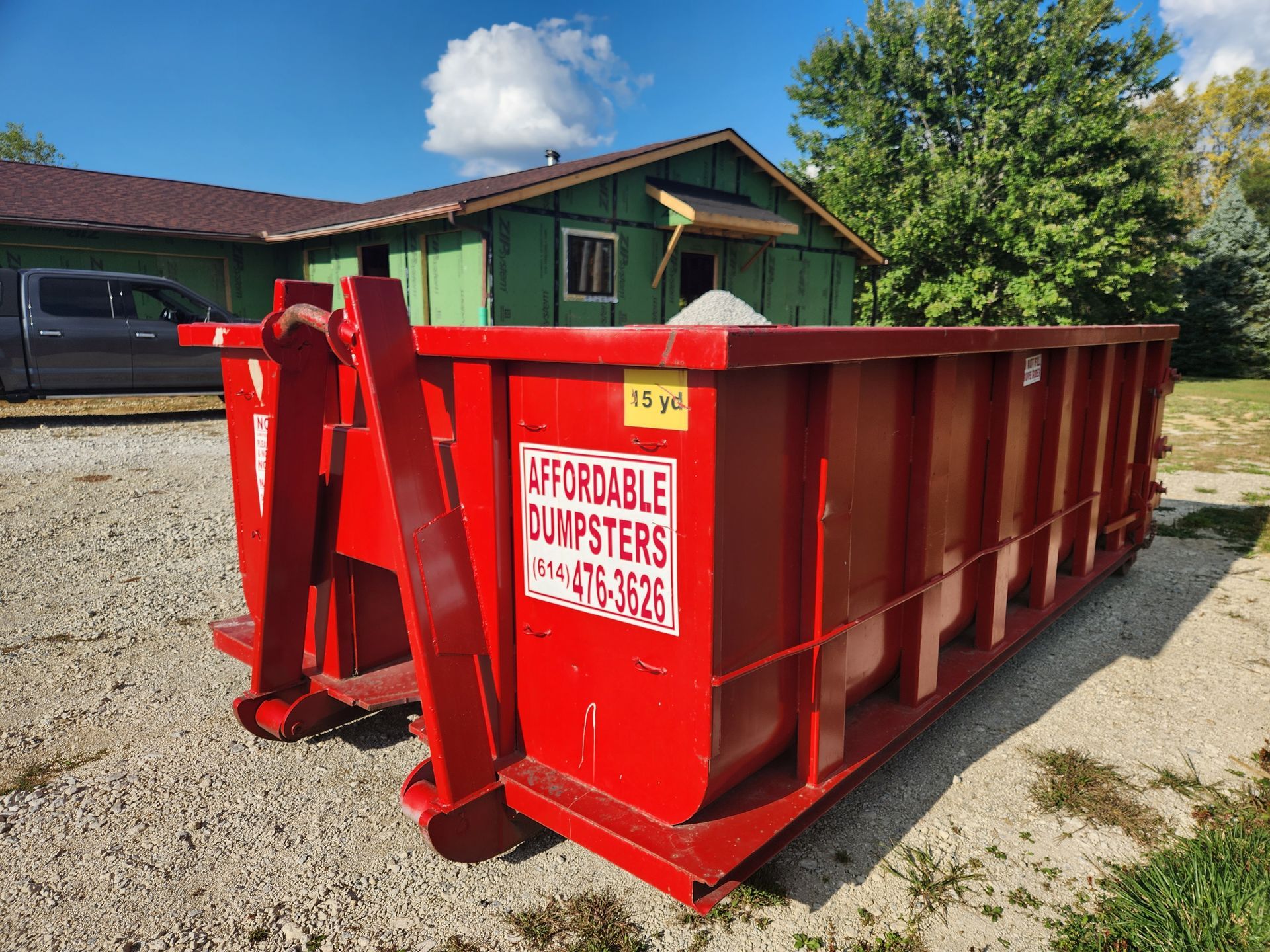 Roll-off trailer used for professional junk removal services and hauling. Roll-off trailer used for professional junk removal services and hauling.