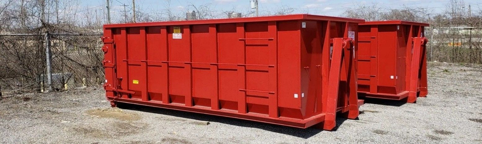 Red 15-yard construction dumpster rental at a new home build site. Red 15-yard construction dumpster rental at a new home build site.