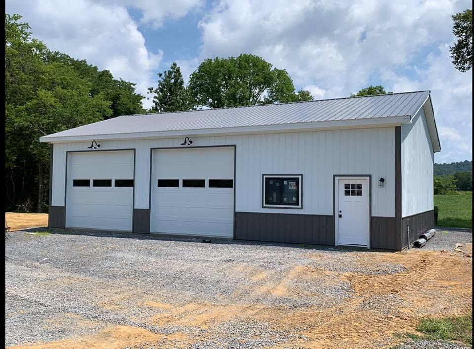 A white and brown garage with two garage doors and a window