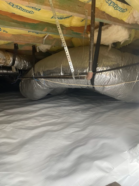 There is a lot of insulation in the ceiling of a room.
