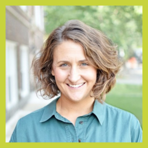 A photograph of a young white woman with shoulder-length brown hair outside wearing a green shirt
